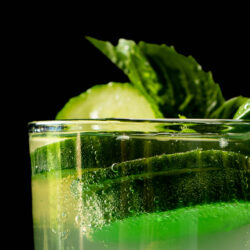 closeup of mocktail with cucumber and basil
